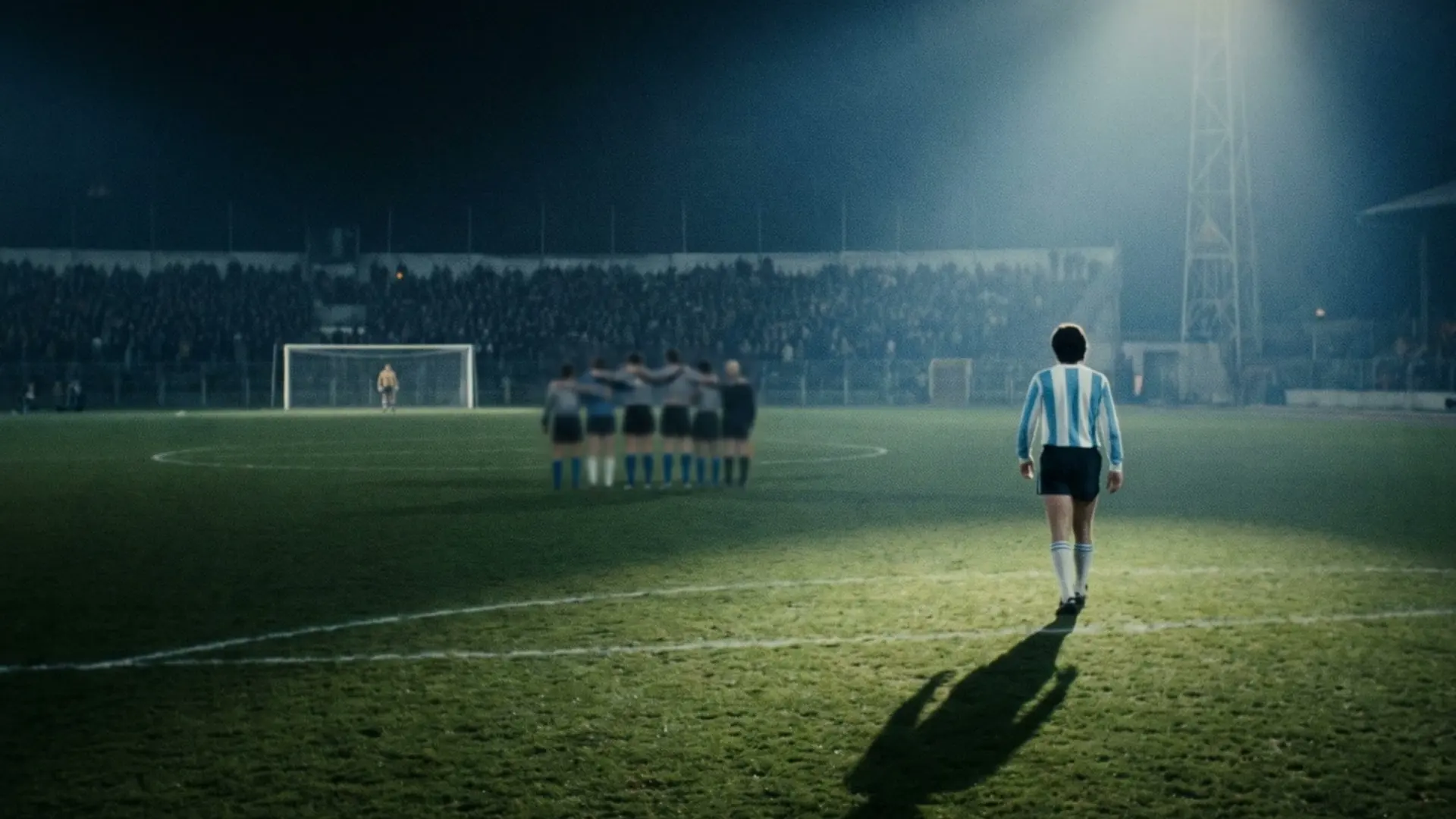 A lone player walking towards a distant goal.