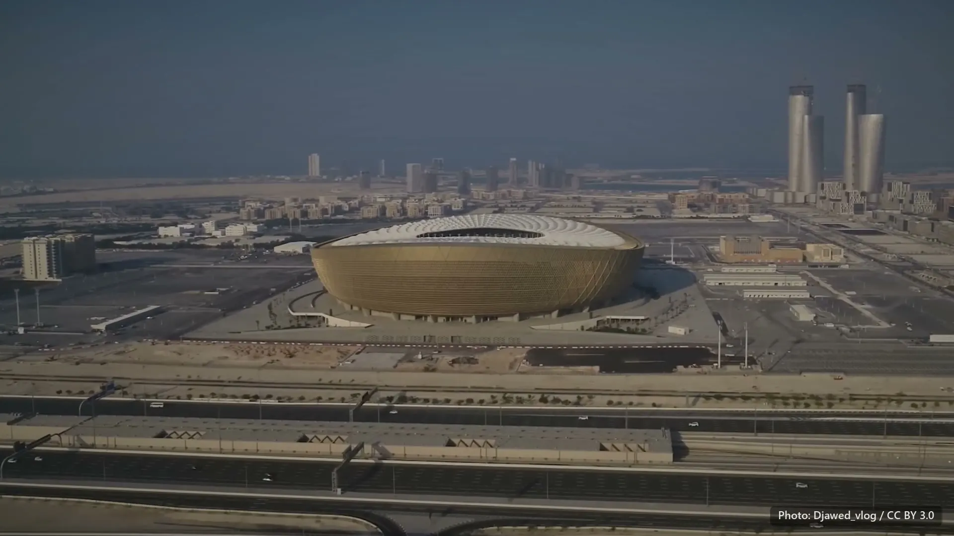 Lusail Stadium, Qatar, from the air in daylight haze.