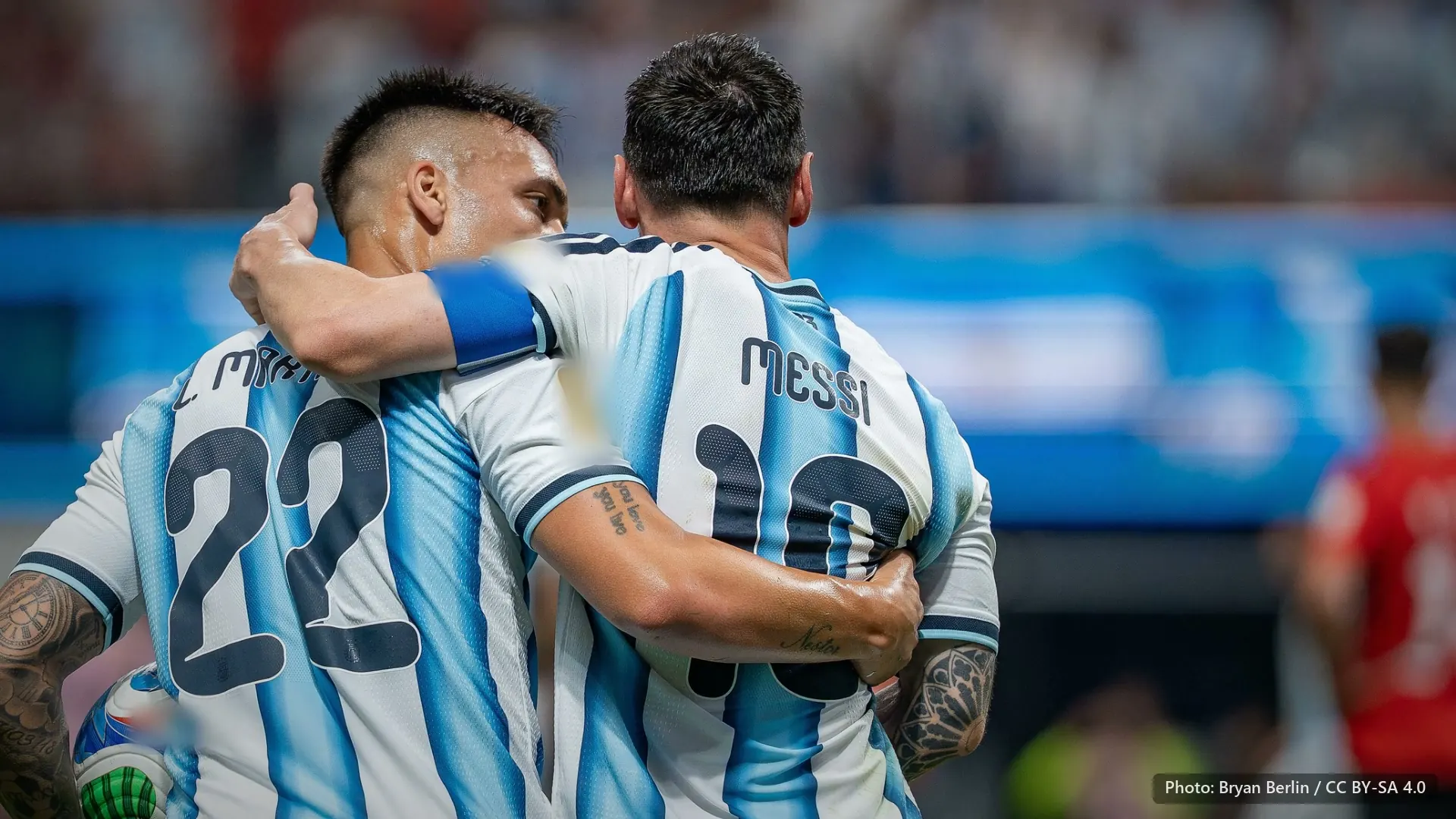 Lautaro Martinez with his arm around Messi, both seen from behind in Argentina stripes. Argentina v Egypt, 7 July 2026.